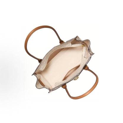 Top-down view of a structured handbag with tan leather handles and a light beige interior, shown on a plain white background.