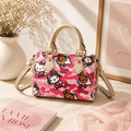 Pink cartoon camo barrel handbag with top handles and adjustable crossbody strap, featuring cute character-inspired graphics, structured faux leather design, and a stylish pink aesthetic for everyday fashion.