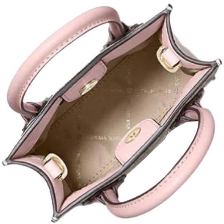 Top-down view of a structured light pink leather handbag with gold-tone hardware, showing the interior lining and double top handles against a white background.