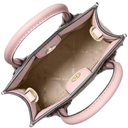 Top-down view of a structured light pink leather handbag with gold-tone hardware, showing the interior lining and double top handles against a white background.